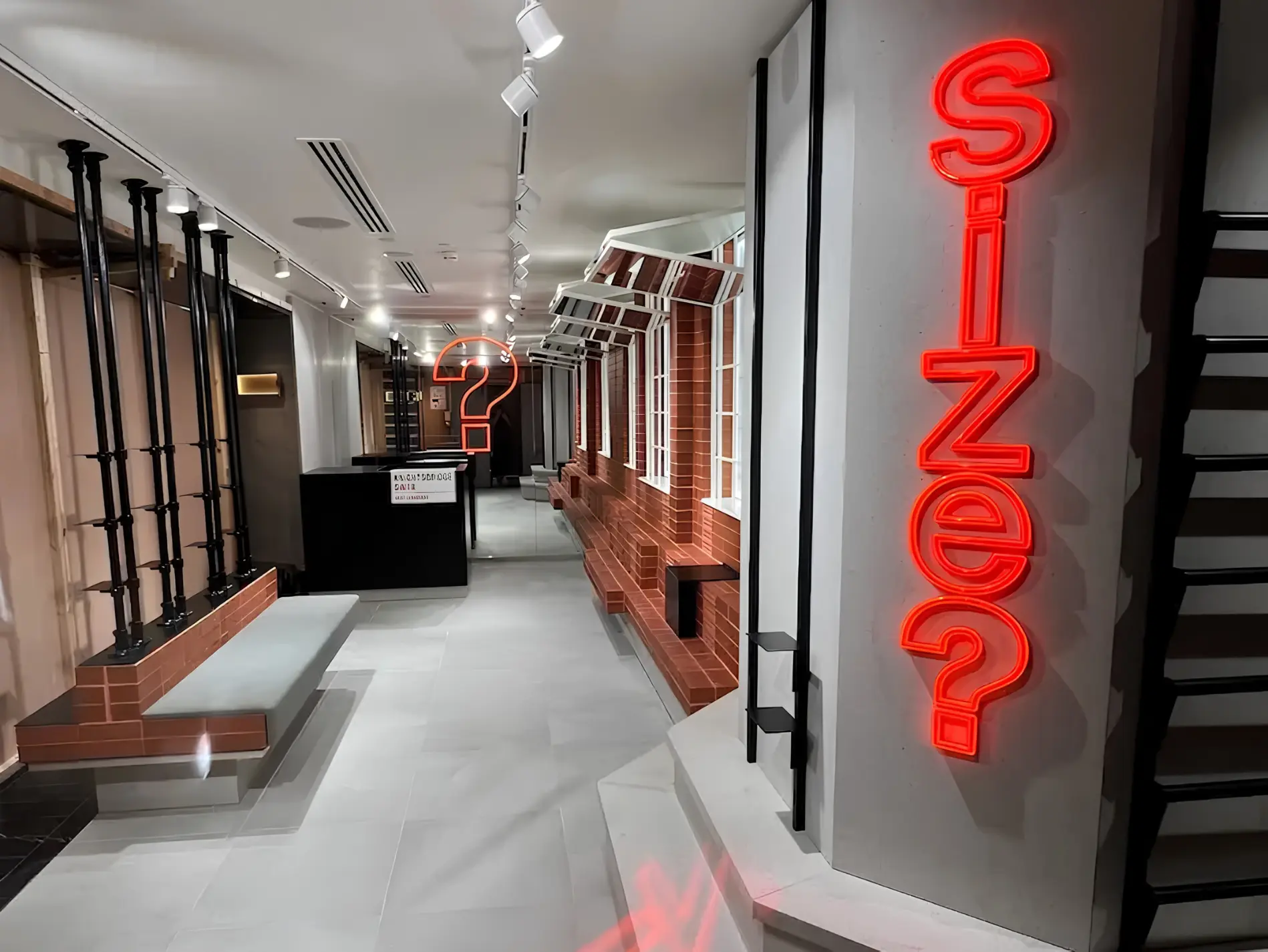 Size? store interior with red illuminated signage, brick detailing and display fixtures