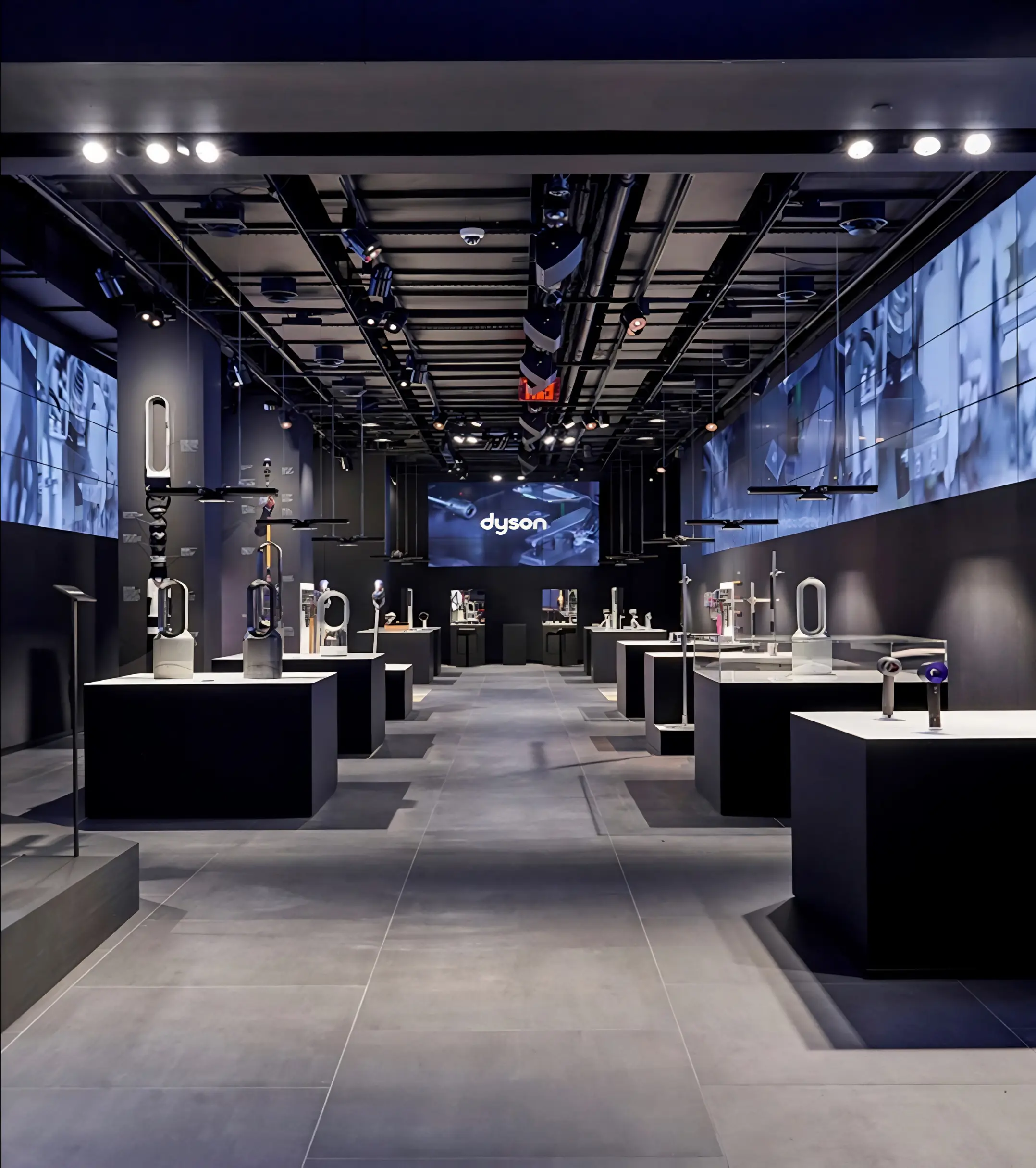 Dyson showroom with illuminated product displays and wall-mounted screens